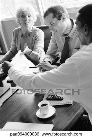 Stock Photograph - Business people examining document, B&W. Fotosearch