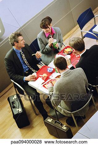 Business people having lunch on trays, elevated view View Large Photo Image Stock Photo - Business people having lunch on trays, elevated view. Fotosearch