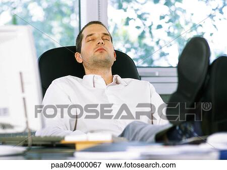 Businessman sitting with feet on desk and eyes closed View Large Photo Image Stock Photo - Businessman sitting with feet on desk and eyes closed. Fotosearch