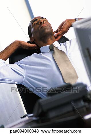 Businessman stretching in armchair View Large Photo Image Stock Photo - Businessman stretching in armchair. Fotosearch