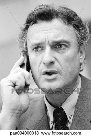 Stock Photo - Businessman using cell phone, close-up, B&W. Fotosearch