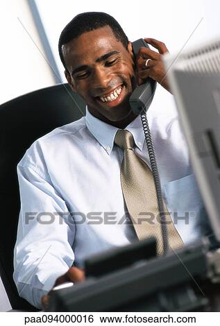 Businessman using telephone, smiling View Large Photo Image Stock Photograph - Businessman using telephone, smiling. Fotosearch