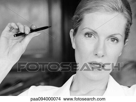 Businesswoman holding pen, close-up, portrait, B&W View Large Photo Image Picture - Businesswoman holding pen, close-up, portrait, B&W. Fotosearch