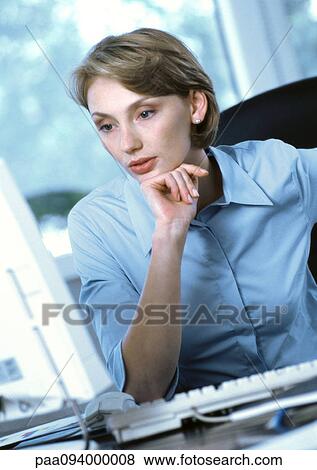 Businesswoman looking at computer View Large Photo Image Stock Photo - Businesswoman looking at computer. Fotosearch