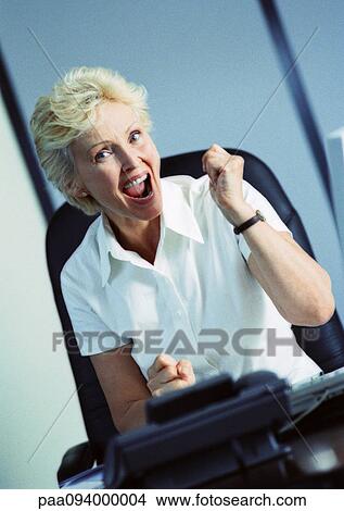 Businesswoman raising fist and smiling, portrait View Large Photo Image Picture - Businesswoman raising fist and smiling, portrait. Fotosearch
