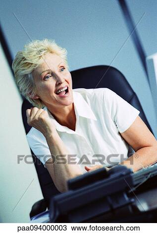 Businesswoman raising fist and smiling View Large Photo Image Stock Image - Businesswoman raising fist and smiling. Fotosearch