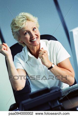 Businesswoman raising fists and smiling, portrait View Large Photo Image Stock Image - Businesswoman raising fists and smiling, portrait. Fotosearch