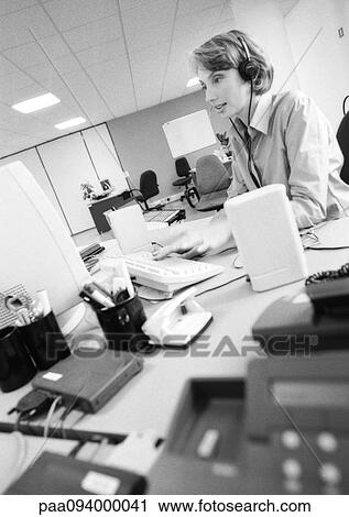 Businesswoman wearing headset in office, side view, B&W View Large Photo Image Stock Image - Businesswoman wearing headset in office, side view, B&W. Fotosearch