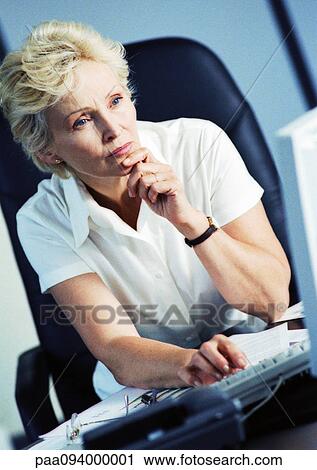 Stock Image - Businesswoman working on computer. Fotosearch