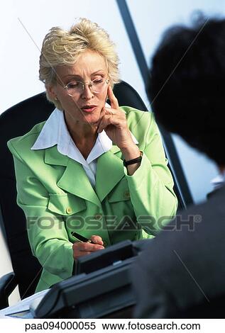 Businesswoman writing, second person in blurred foreground View Large Photo Image Stock Photography - Businesswoman writing, second person in blurred foreground. Fotosearch