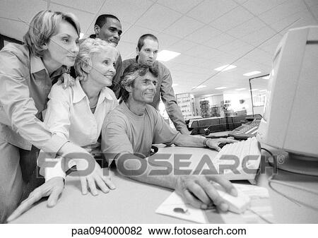 Group of business people looking at computer, B&W View Large Photo Image Stock Image - Group of business people looking at computer, B&W. Fotosearch