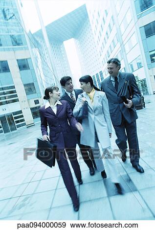 Group of business people walking outdoors View Large Photo Image Stock Photo - Group of business people walking outdoors. Fotosearch