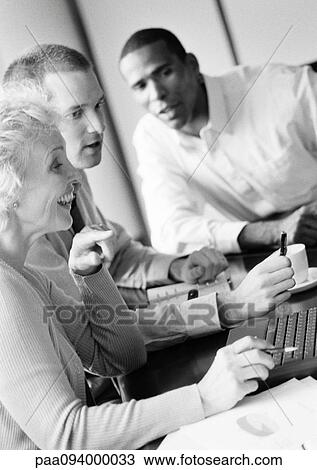 Mature businesswoman in conference, smiling, profile, with two businessmen, B&W View Large Photo Image Stock Image - Mature businesswoman in conference, smiling, profile, with two businessmen, B&W. Fotosearch