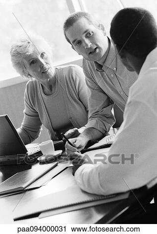 Mature businesswoman in conference with two businessmen, B&W View Large Photo Image Stock Image - Mature businesswoman in conference with two businessmen, B&W. Fotosearch