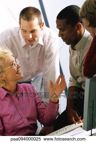 Mature businesswoman talking to other businesspeople View Large Photo Image Stock Photography - Mature businesswoman talking to other businesspeople. Fotosearch