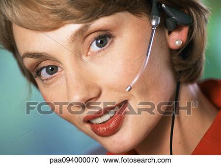 Woman wearing headset, looking at camera, close-up, portrait View Large Photo Image Stock Image - Woman wearing headset, looking at camera, close-up, portrait. Fotosearch