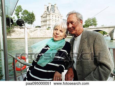 Stock Image - France, Paris, mature man and woman on a boat in the River Seine. Fotosearch