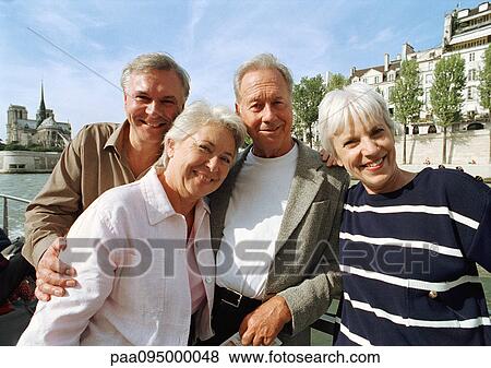 France, Paris, mature men and women posing in front of the River Seine View Large Photo Image Stock Photo - France, Paris, mature men and women posing in front of the River Seine. Fotosearch