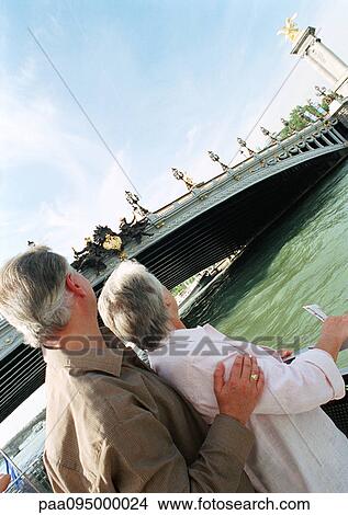 France, Paris, mature woman and man looking at the Pont Alexandre III View Large Photo Image Picture - France, Paris, mature woman and man looking at the Pont Alexandre III. Fotosearch