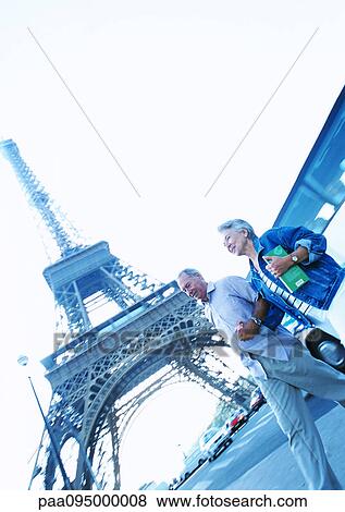 France, Paris, mature woman and man walking in front of Eiffel Tower View Large Photo Image Stock Photo - France, Paris, mature woman and man walking in front of Eiffel Tower. Fotosearch