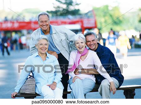 Stock Image - Group of mature people on a bench, portrait. Fotosearch