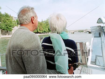 Picture - Mature man and woman on a boat, rear view. Fotosearch