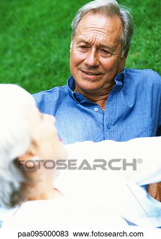 Mature man and woman on the grass, blurred foreground, close-up View Large Photo Image Stock Image - Mature man and woman on the grass, blurred foreground, close-up. Fotosearch