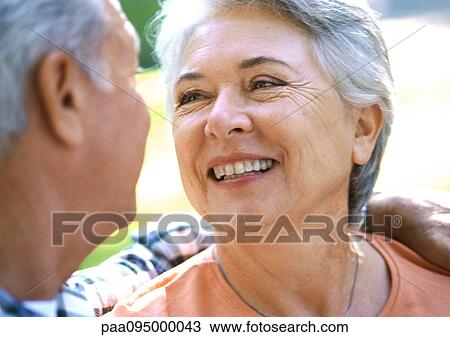 Stock Image - Mature man and woman smiling, close-up. Fotosearch