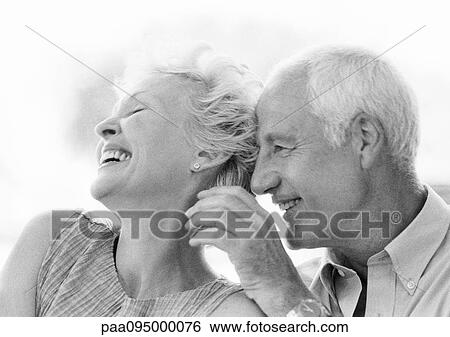 Stock Photograph - Mature man and woman smiling, close-up, B&W. Fotosearch
