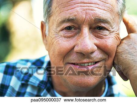 Stock Photo - Mature man smiling at camera, close-up, portrait. Fotosearch