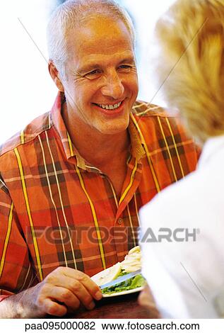 Mature man smiling at mature woman, close-up View Large Photo Image Stock Image - Mature man smiling at mature woman, close-up. Fotosearch