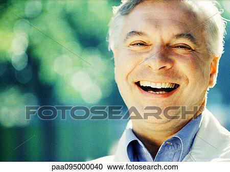 Stock Image - Mature man smiling, close-up, portrait. Fotosearch