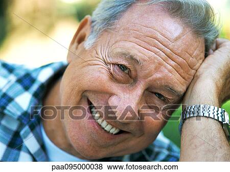 Stock Photo - Mature man smiling, close-up, portrait. Fotosearch