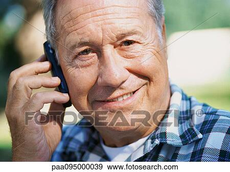 Stock Photo - Mature man with a cell phone, close-up, portrait. Fotosearch