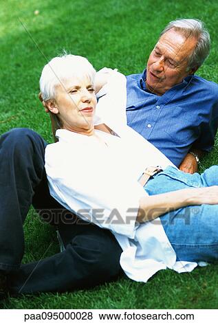 Mature woman and man lying on grass View Large Photo Image Stock Photo - Mature woman and man lying on grass. Fotosearch