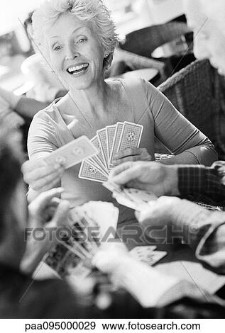 Mature woman playing cards, blurred foreground, B&W View Large Photo Image Stock Photo - Mature woman playing cards, blurred foreground, B&W. Fotosearch
