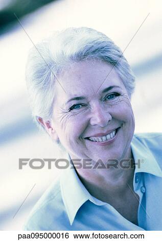 Mature woman smiling at camera, portrait View Large Photo Image Stock Photograph - Mature woman smiling at camera, portrait. Fotosearch