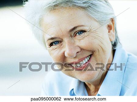 Stock Image - Mature woman smiling, close-up, portrait. Fotosearch