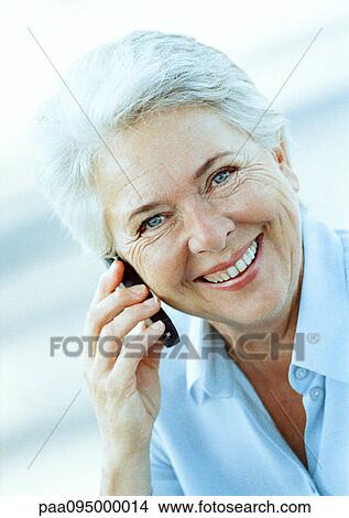Mature woman with cell phone, portrait View Large Photo Image Picture - Mature woman with cell phone, portrait. Fotosearch