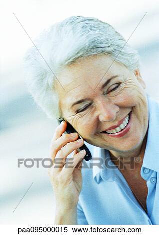 Mature woman with cell phone, smiling with eyes closed View Large Photo Image Stock Photography - Mature woman with cell phone, smiling with eyes closed. Fotosearch