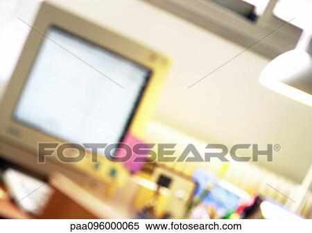 Stock Photography - Computer screen on desk, blurred. Fotosearch
