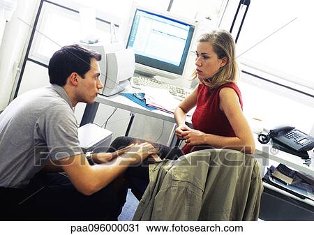 Man and woman discussing in office View Large Photo Image Stock Image - Man and woman discussing in office. Fotosearch