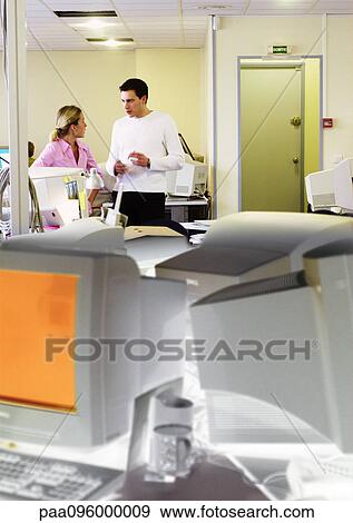 Man and woman talking in office View Large Photo Image Stock Photo - Man and woman talking in office. Fotosearch