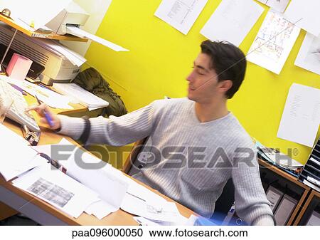 Man working at desk, blurred View Large Photo Image Stock Image - Man working at desk, blurred. Fotosearch