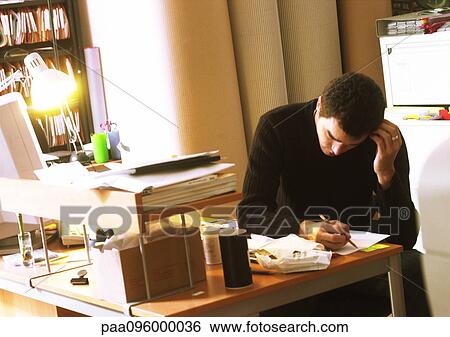 Man working at desk, head down View Large Photo Image Stock Photograph - Man working at desk, head down. Fotosearch