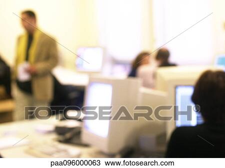 Stock Image - People in office, blurred. Fotosearch