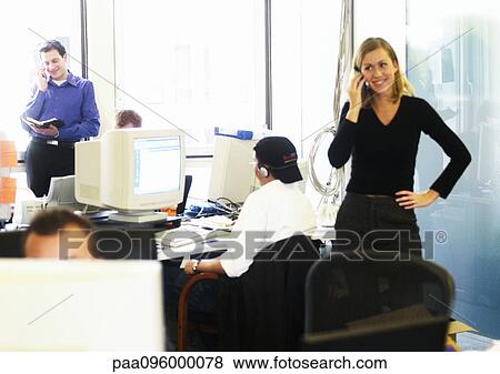 Stock Photo - People using telephones and computers in office. Fotosearch