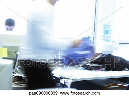 Stock Photo - People working in office, blurred motion. Fotosearch