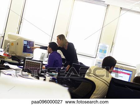 Stock Photo - People working on computers in office. Fotosearch