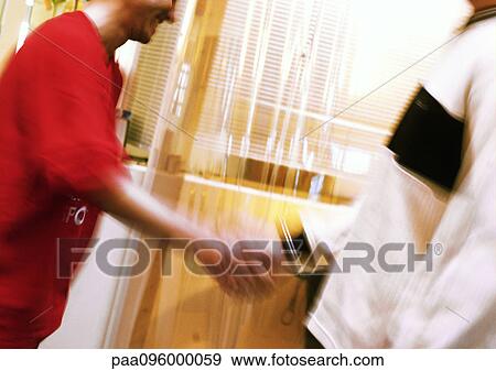 Stock Photo - Two people shaking hands, blurred motion. Fotosearch